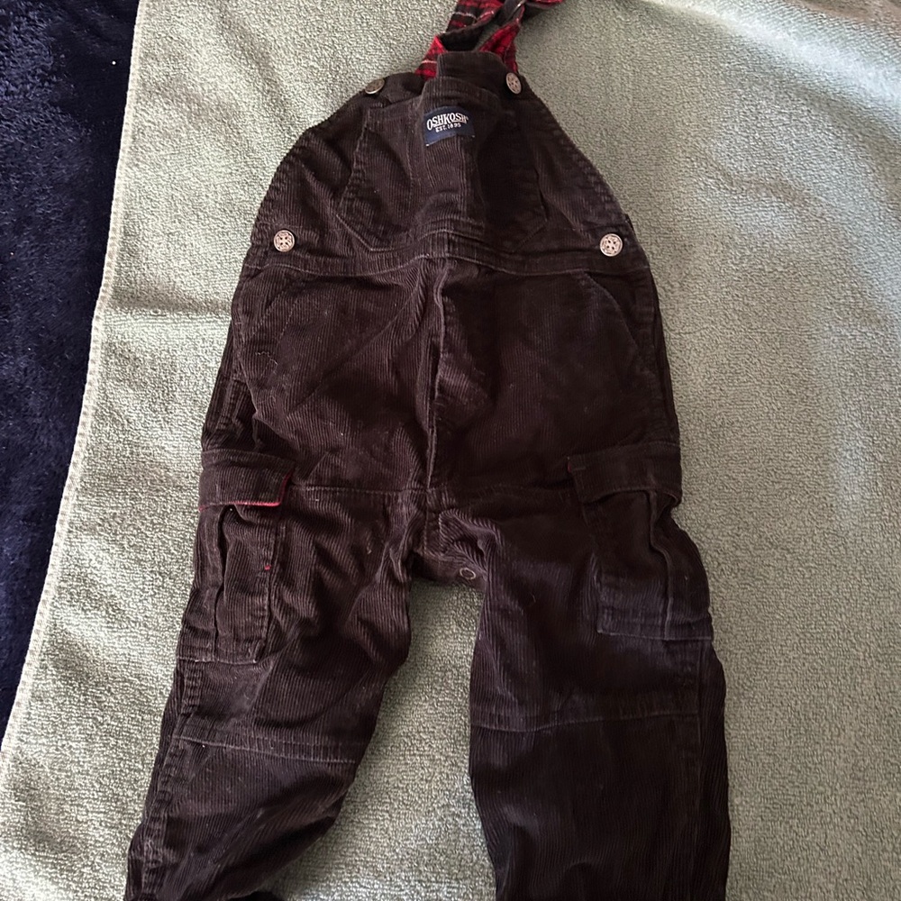 OshKosh B'gosh black corduroy overalls with red plaid accents